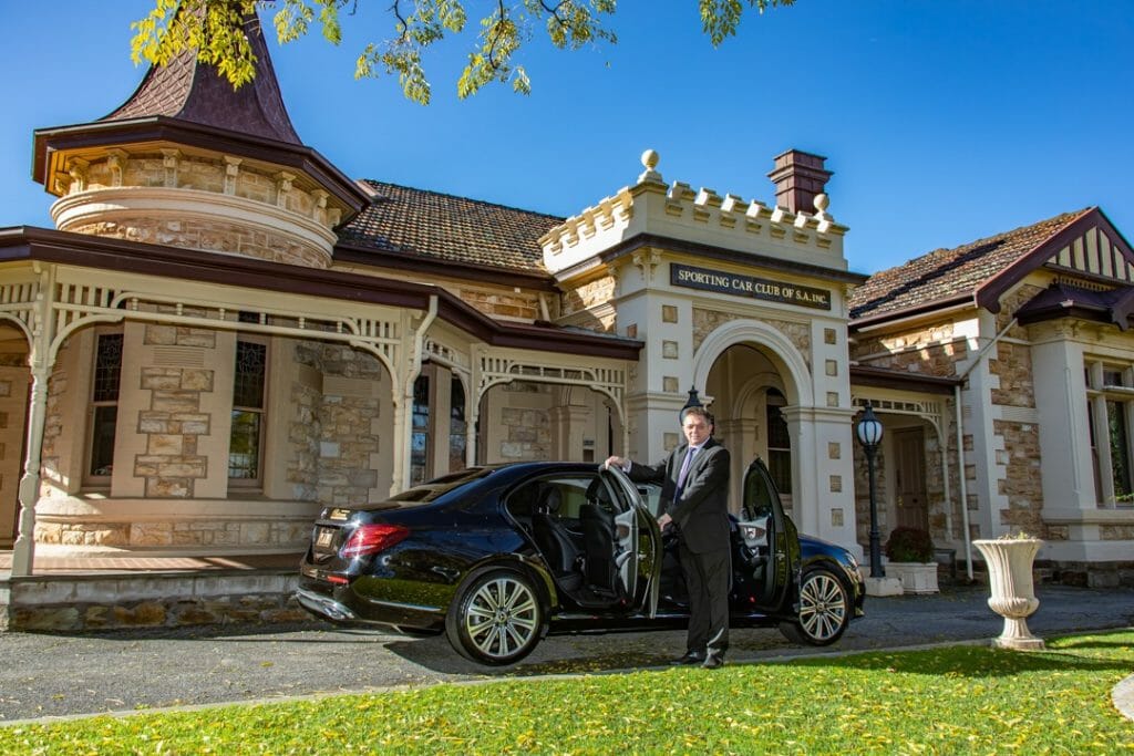 Chauffeur holding open door