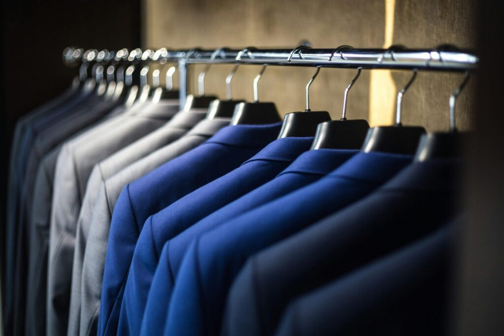 suits hanging from a railing