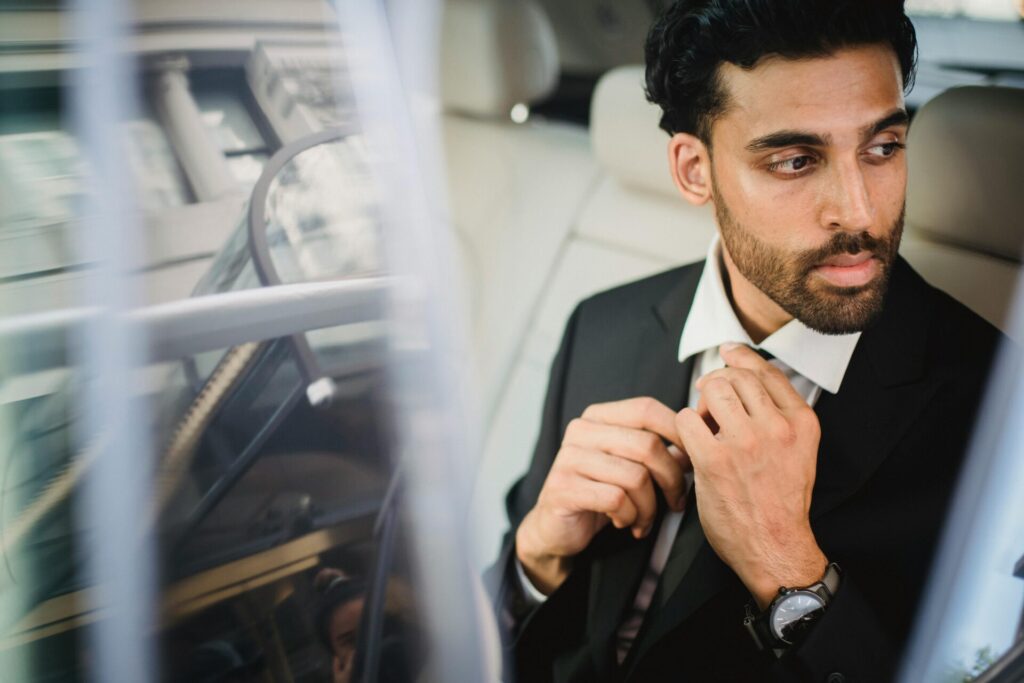 man in suit in car