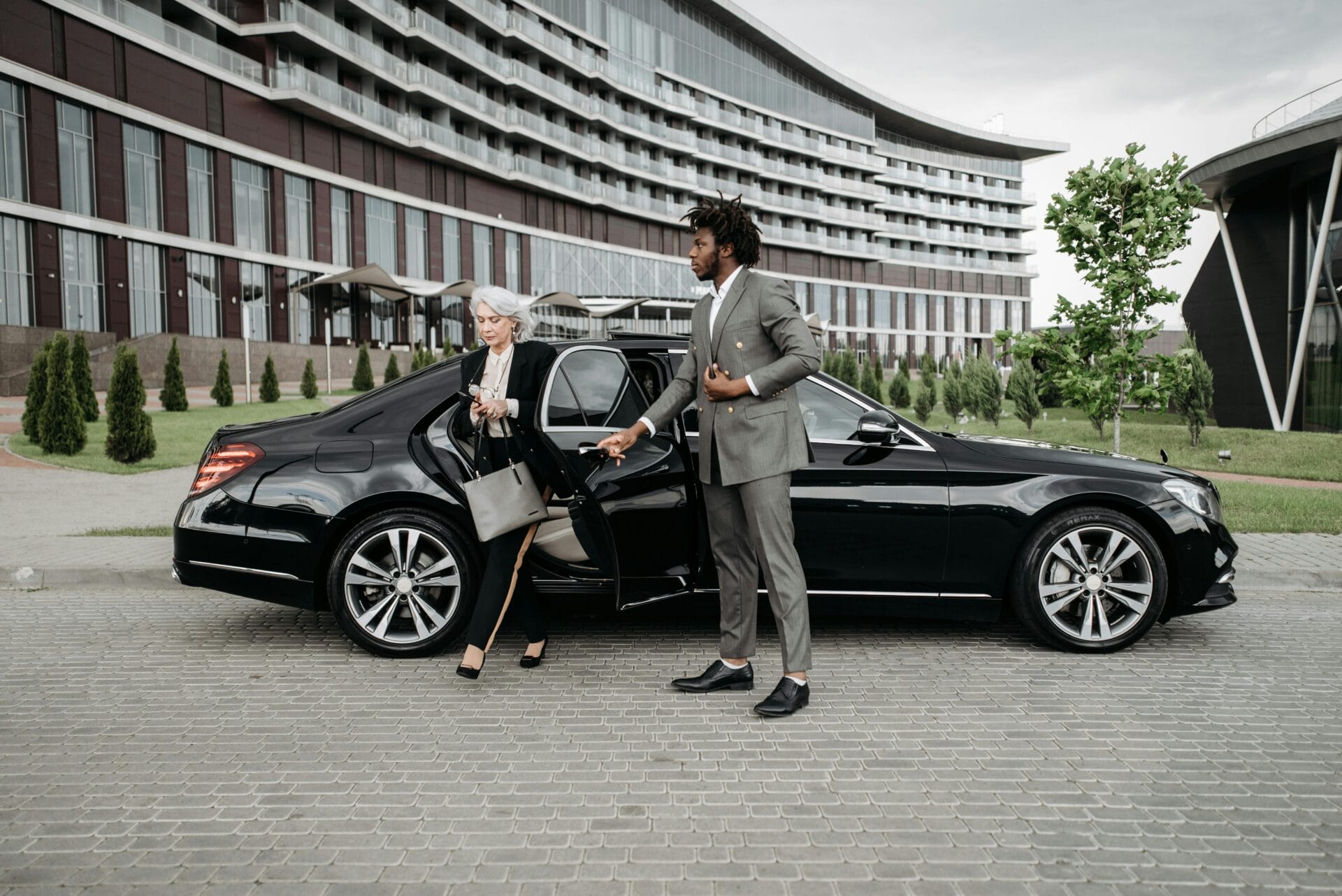 chauffeur opening door for client