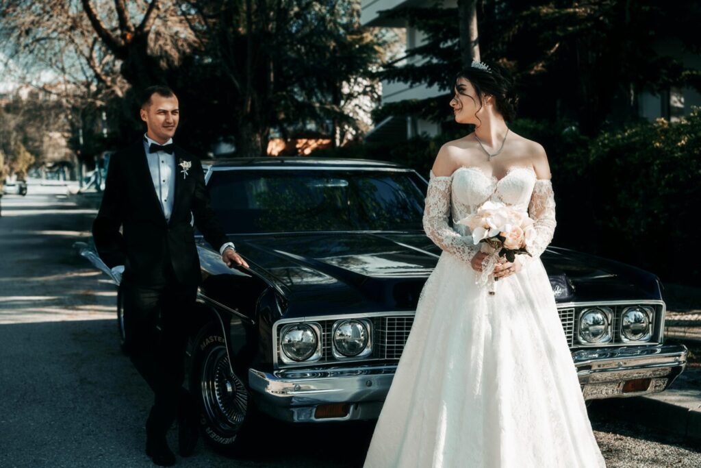 married couple with an old car